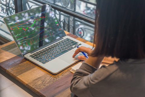 Female Investor Monitoring Her Stocks On Laptop